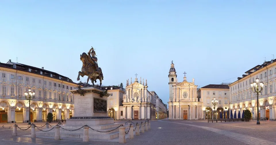 Piazza San Carlo at dawn, with the arcades, the equestrian statue and the twin churches